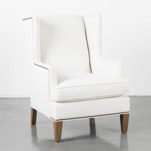 White wing chair with exposed brown feet and nailhead trim product image