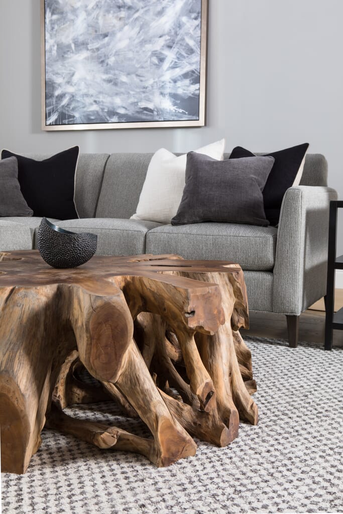 Gray sectional in living room with natural teak wood cocktail table