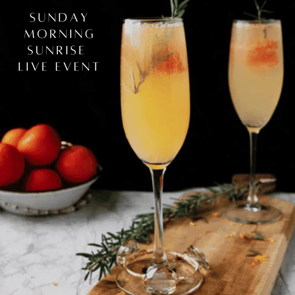 mimosas in champagne flutes on wood plank