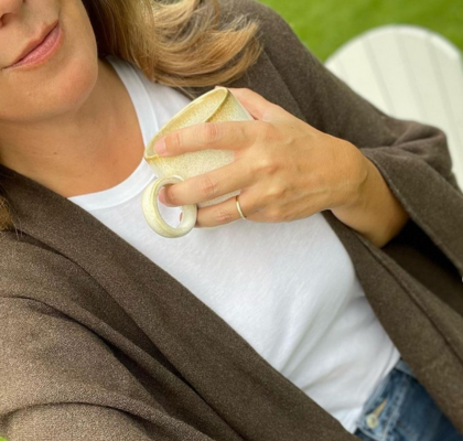 lady with a drink in her hand wearing a travel wrap