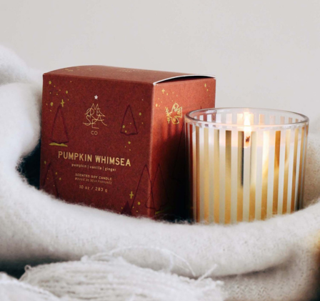 pumpkin candle in a basket with its matching box