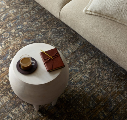 small round coffee table with area rug