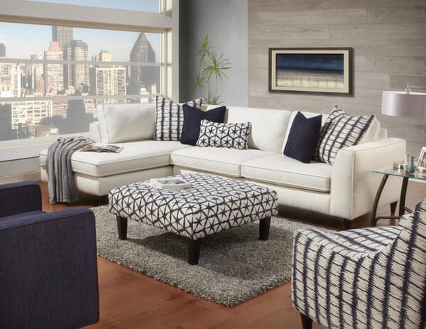 A white sectional room group with ottoman and accent chair