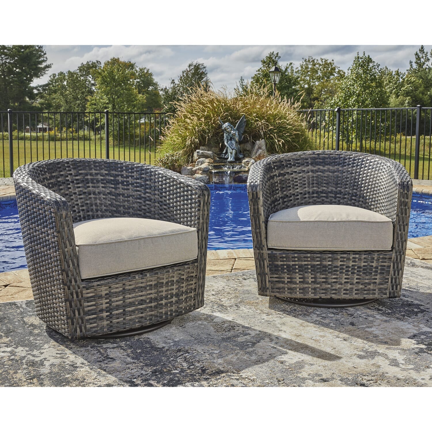 Blue Sky S/2 outdoor swivel chair with resin wicker and an upholstered cushion in a neutral tone