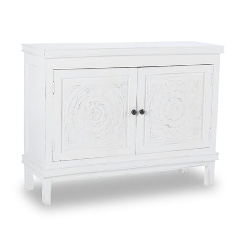 white cabinet with two doors and carved detail