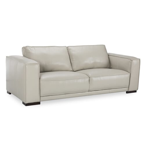 white leather sofa with boxed arms and exposed wooden legs