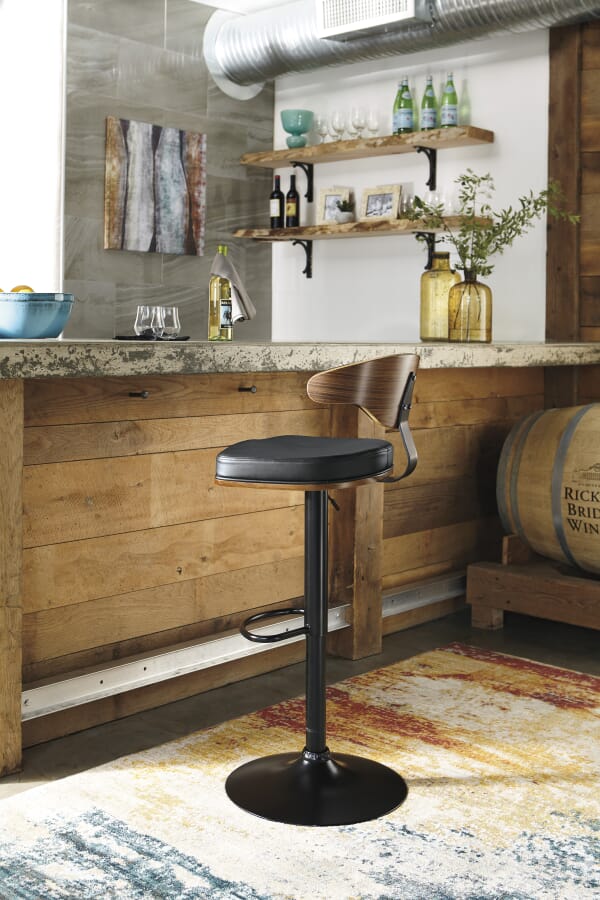 black leather upholstered stool with wood back in home bar setting